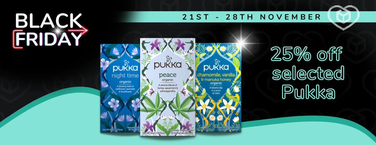 Three Pukka organic herbal tea packets on a black background