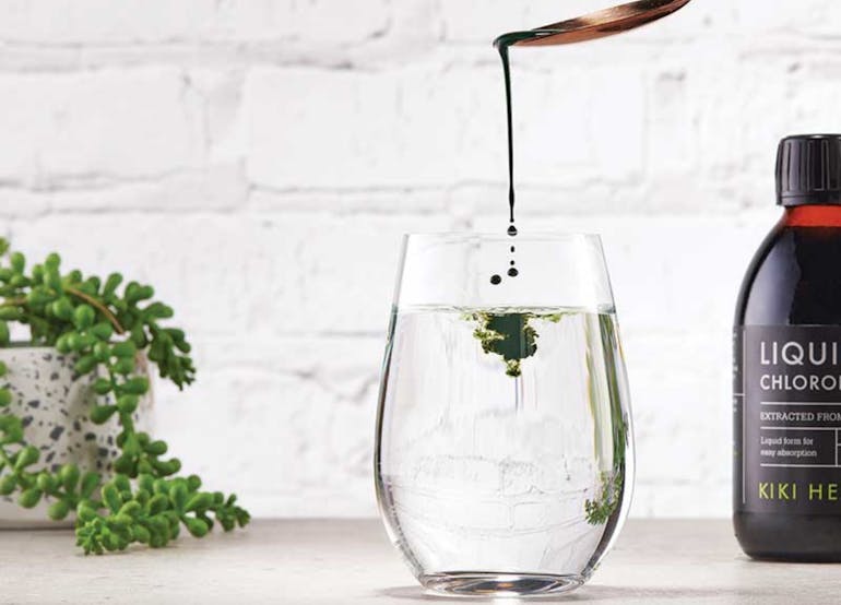 Kiki Health Liquid Chlorophyll being poured into a glass of water: shop Kiki Health at medino