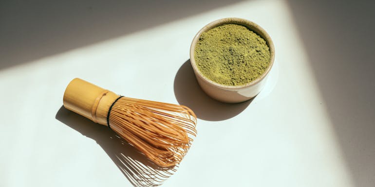 matcha whisk and a cup