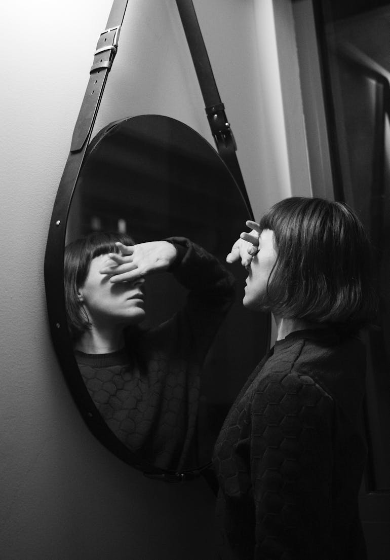 woman-looking-into-mirror