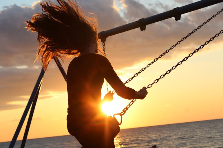 woman-on-swing-sunset